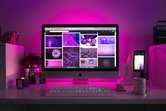Purple backlit computer monitor and desk